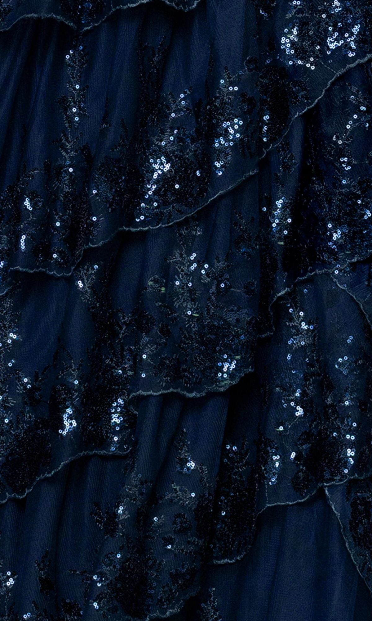 Close-up of the Blondie Nites 6126BN long prom dress, featuring dark blue layered ruffles and sparkling sequins for a shimmering corset-style bodice and tiered A-line skirt.